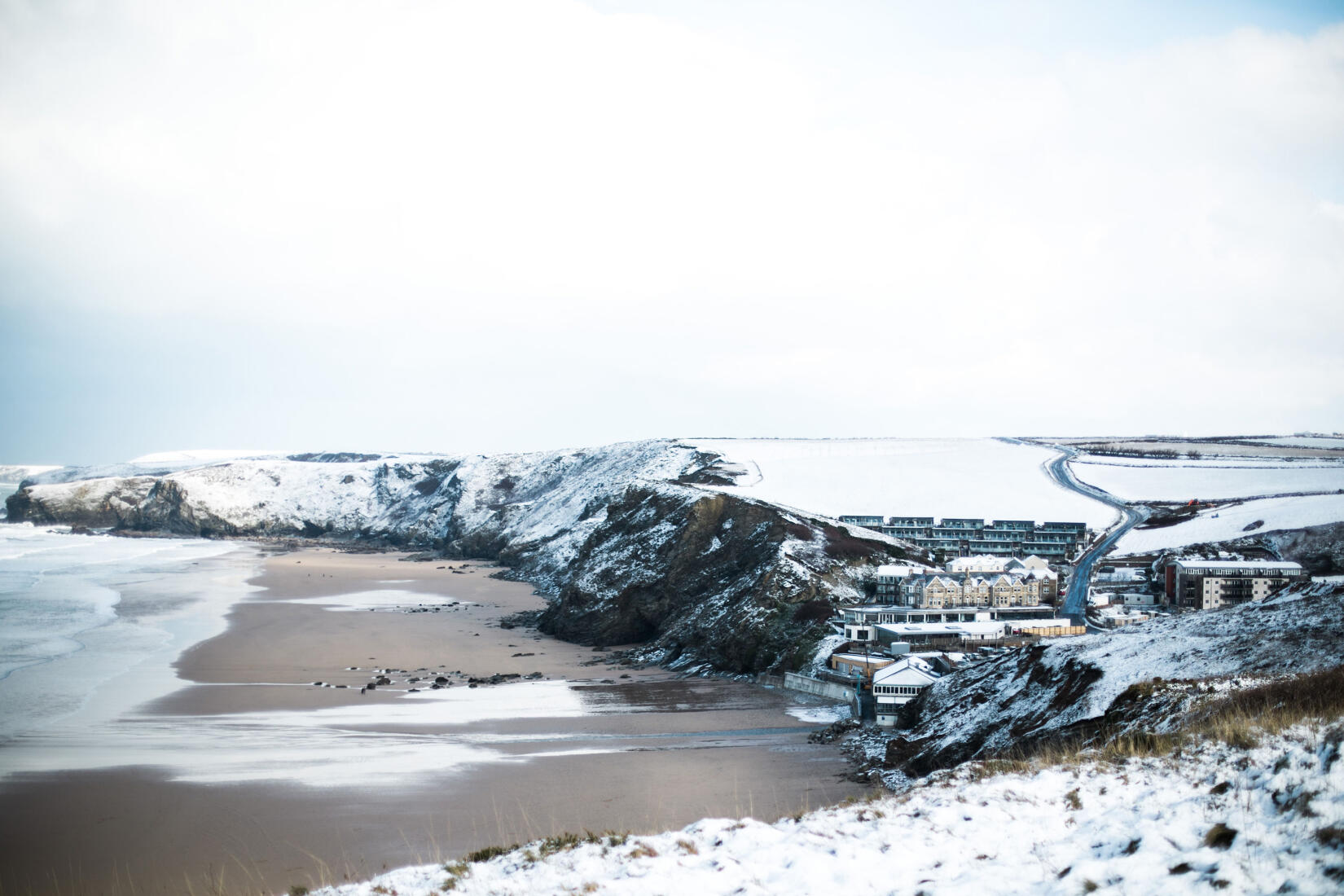 View over the hotel and the beach in the snow at Christmas