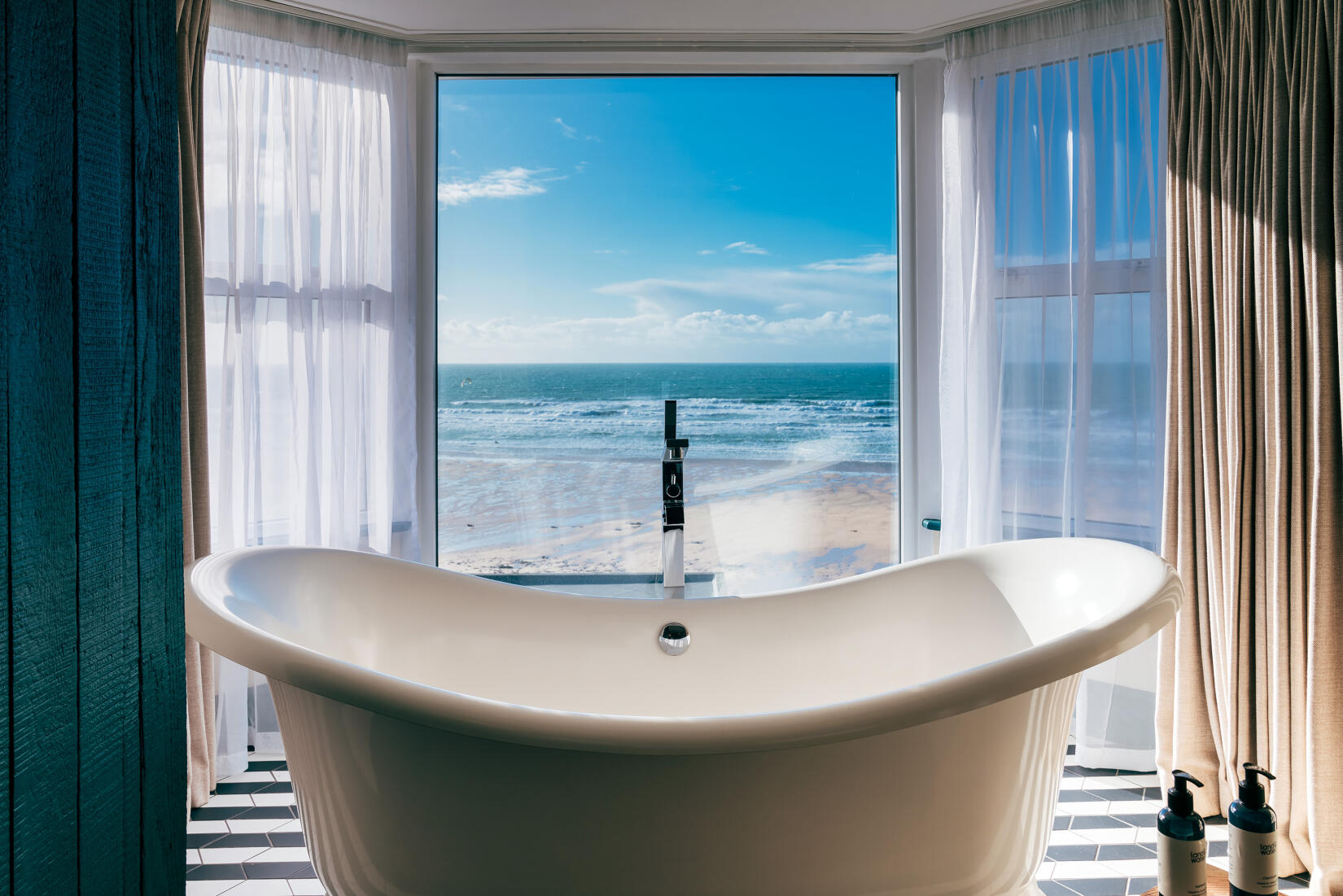 Roll-top bath in the window of a suite bedroom