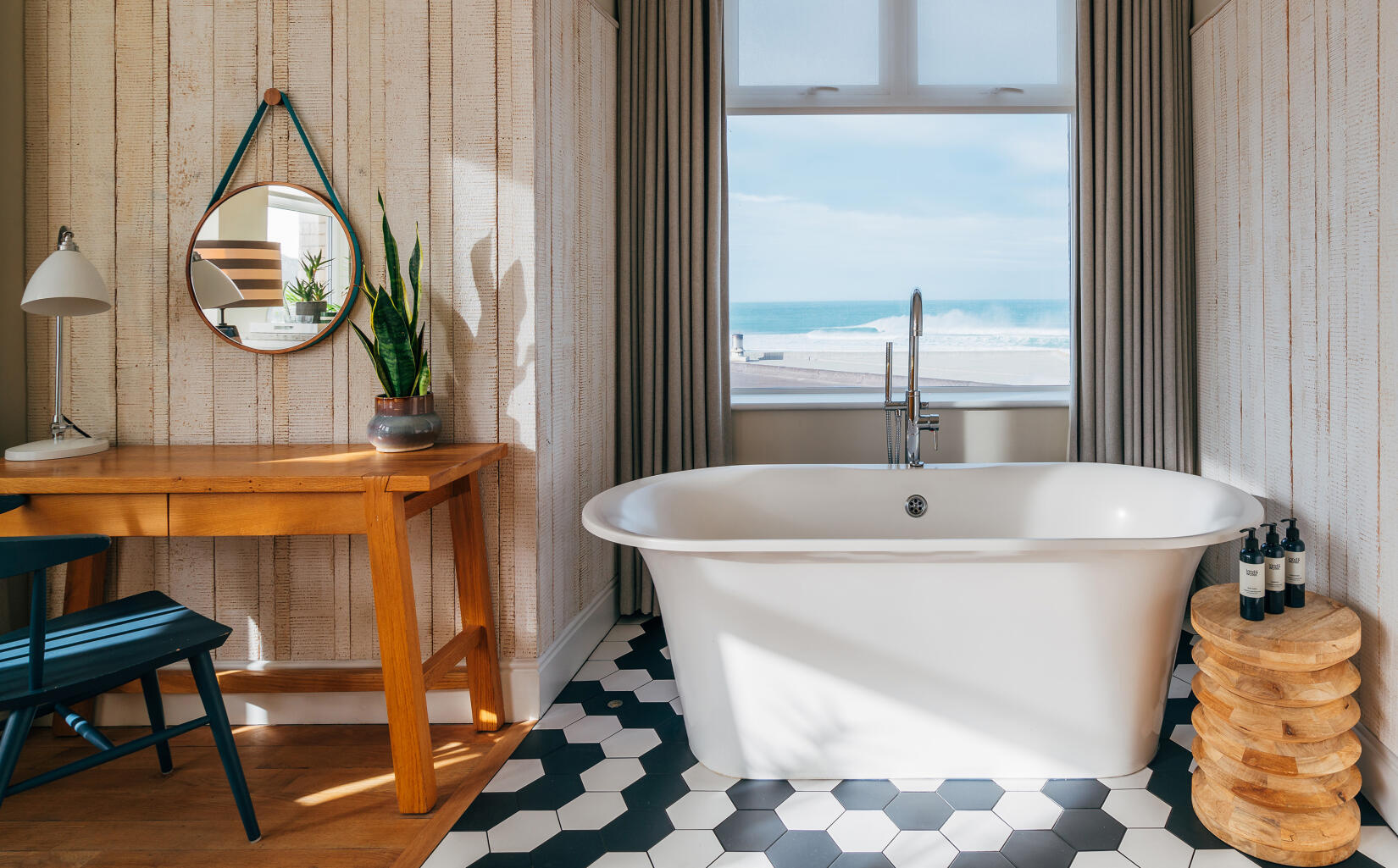 Roll-top bath in the window of a double bedroom