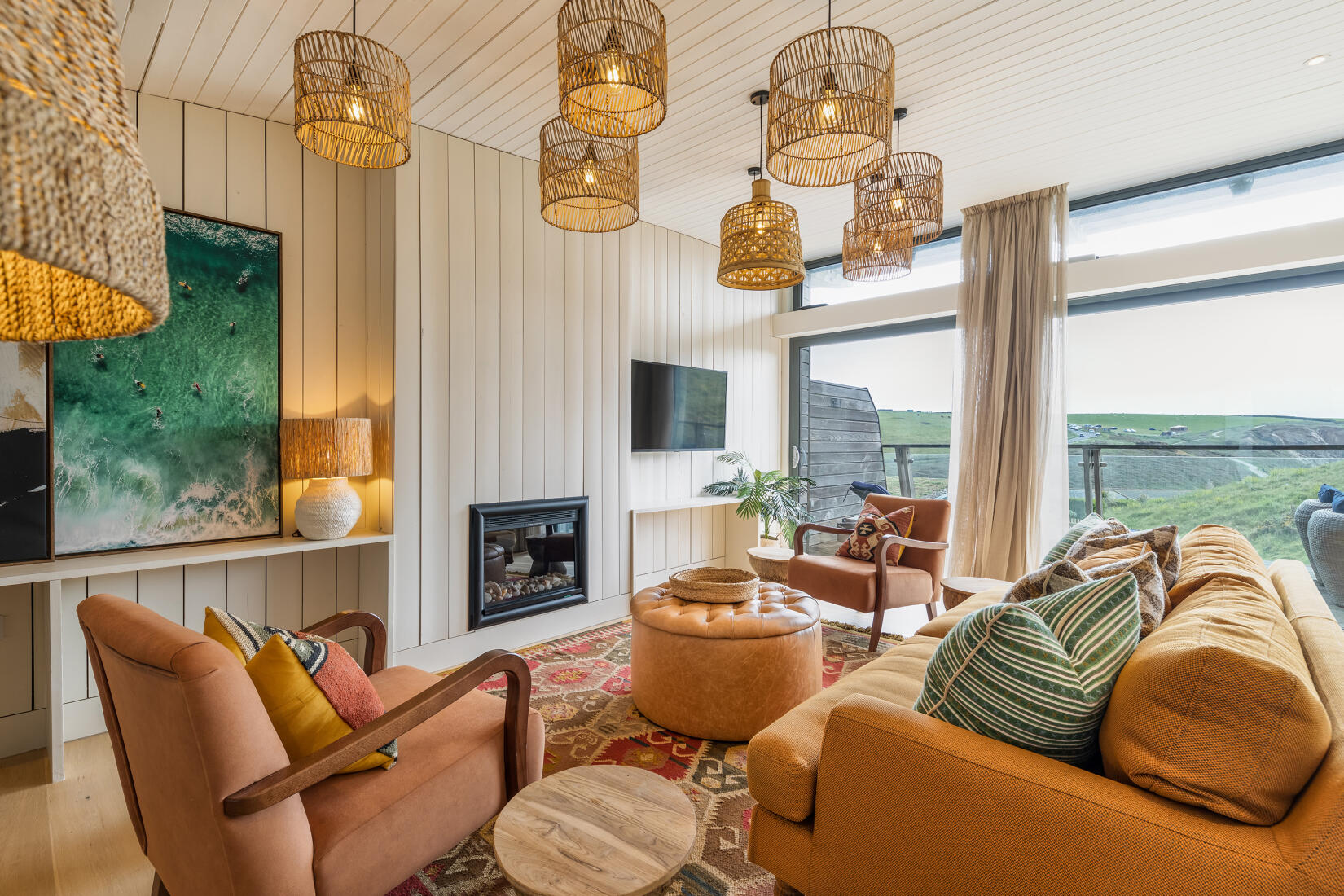 Apartment living room with fire and views over the bay