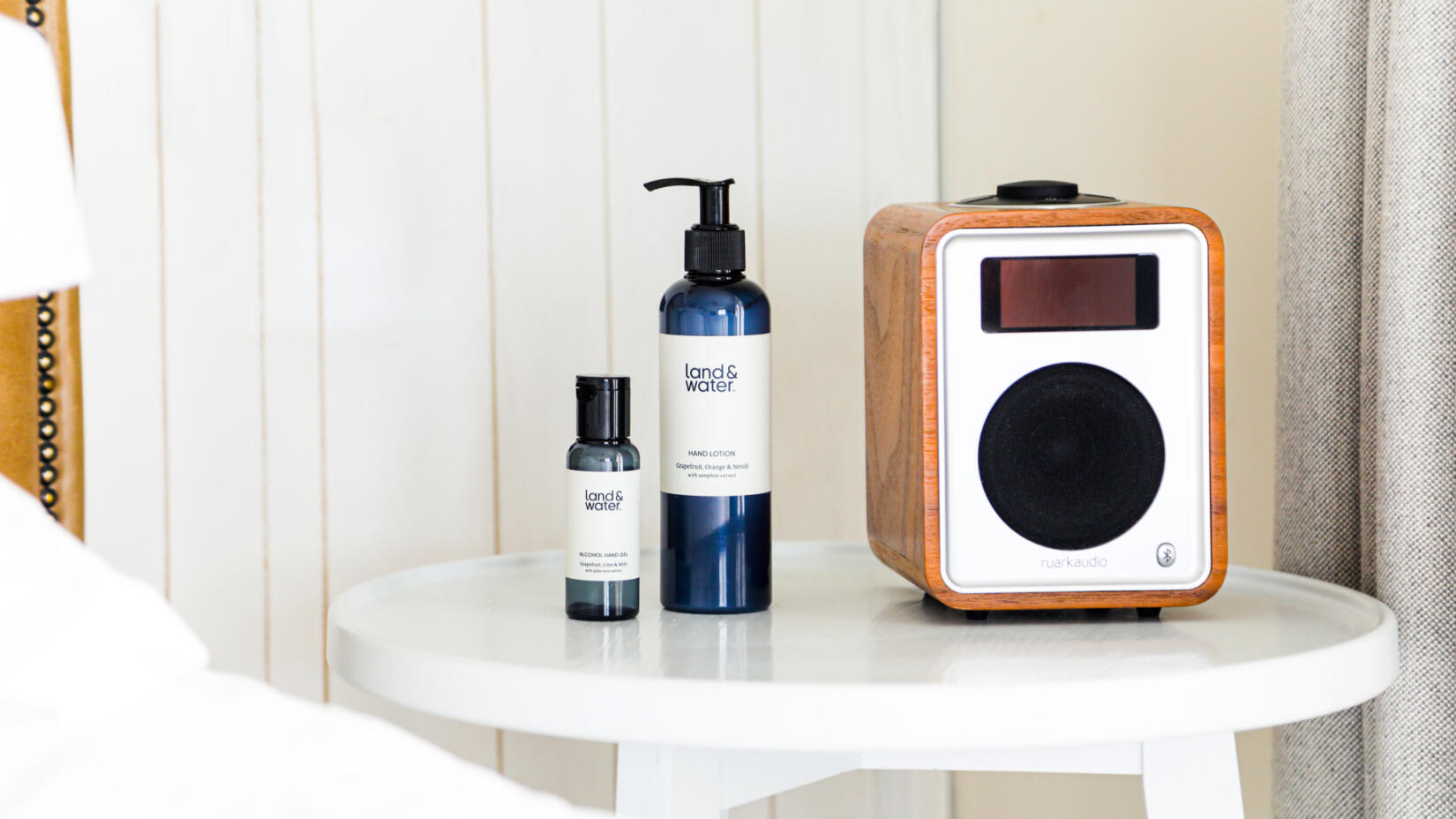 Ruark radio on bedside table with land&water