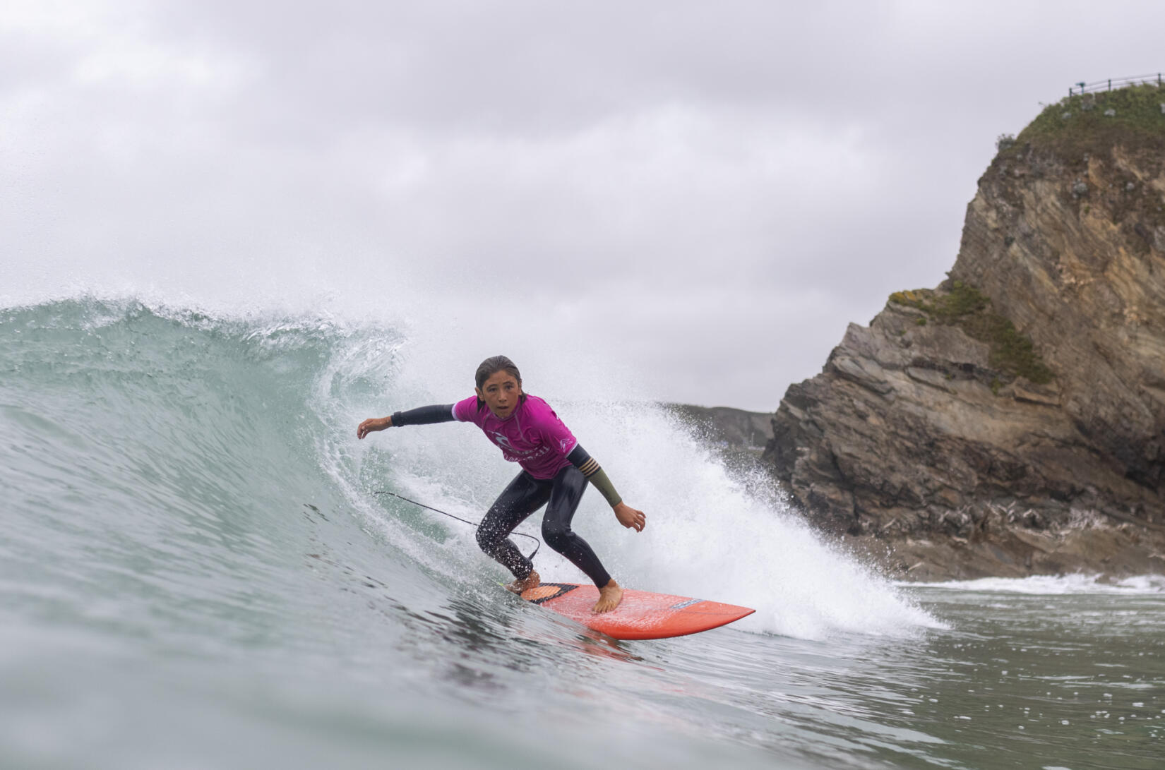 Girl surfing for Rip Curl