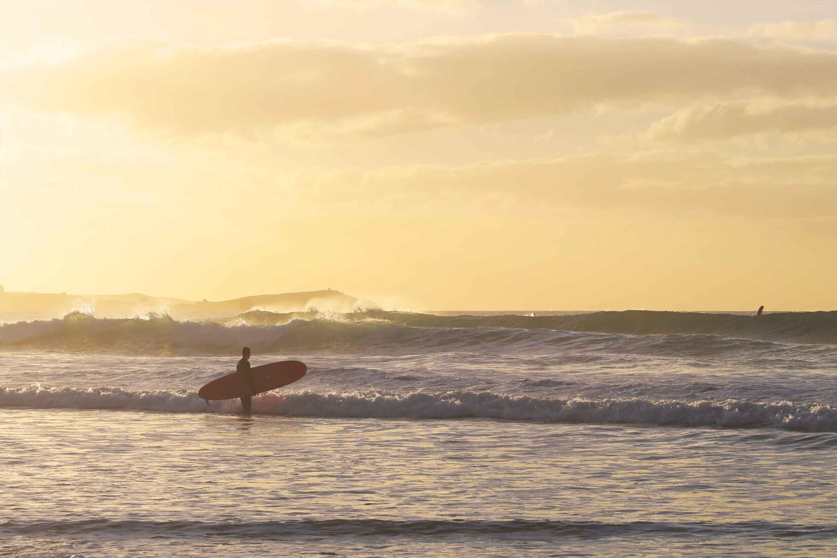 Surfers at sundown Wavehunters