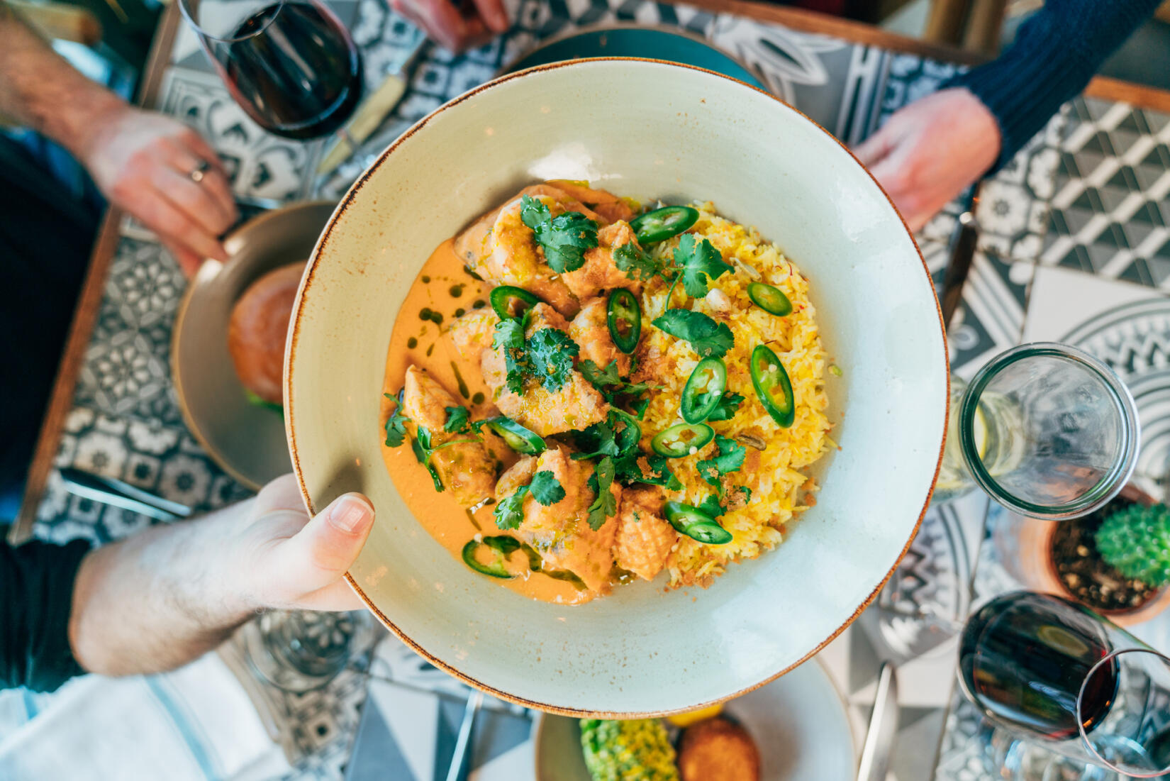 A bowl of fish korma being served