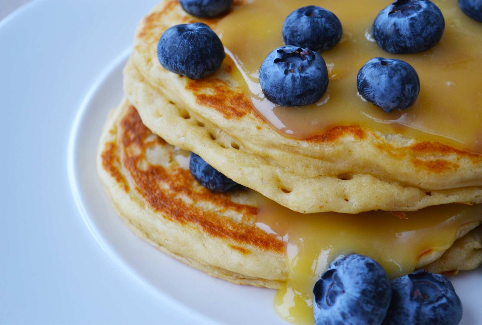 lemon pancakes on a plate with blueberries