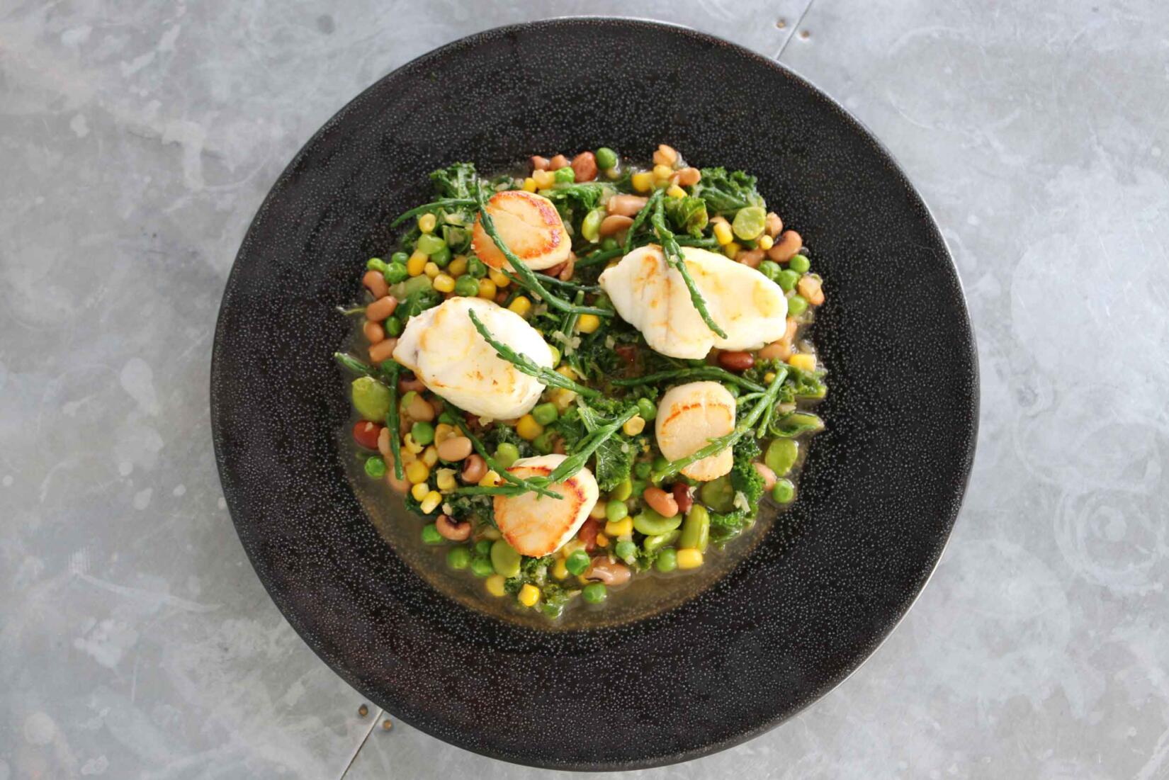 Scallop and monkfish succotash recipe in a bowl with vegetables