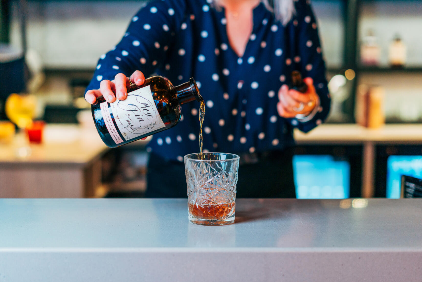 Negroni cocktail being poured in to a short glass