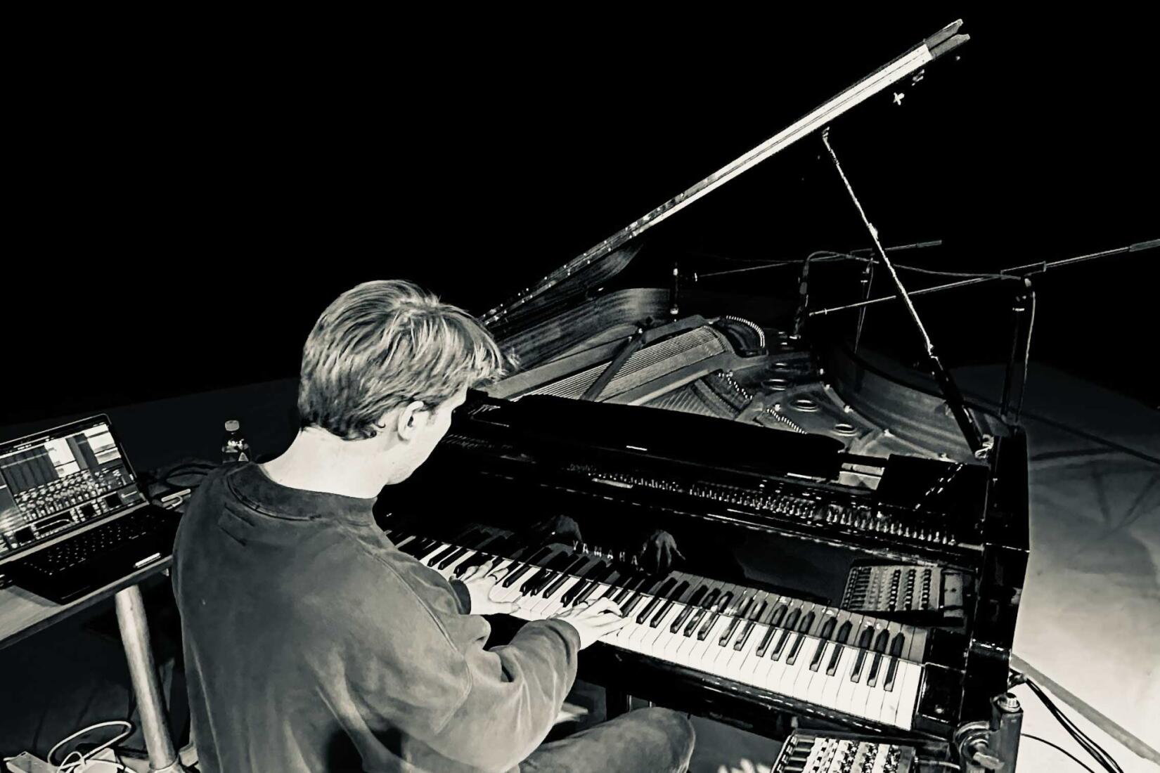 Joe Kirby sitting at his piano