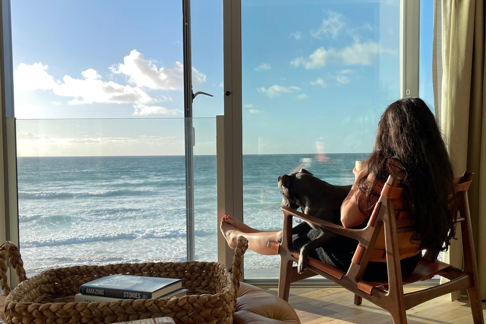 Melissa Hemsley sitting in the beach lofts with a dog