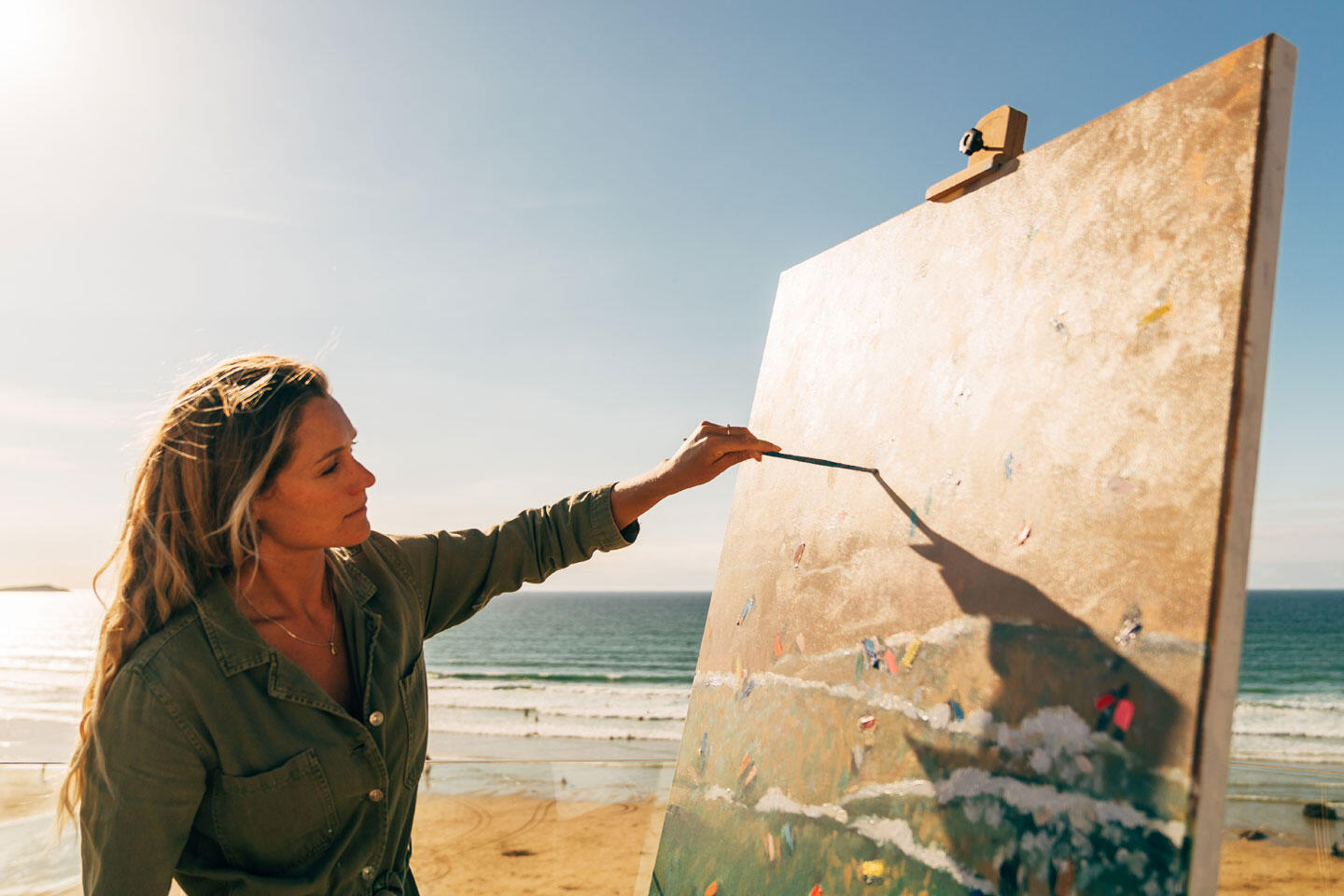 Nina painting on Watergate Bay beach