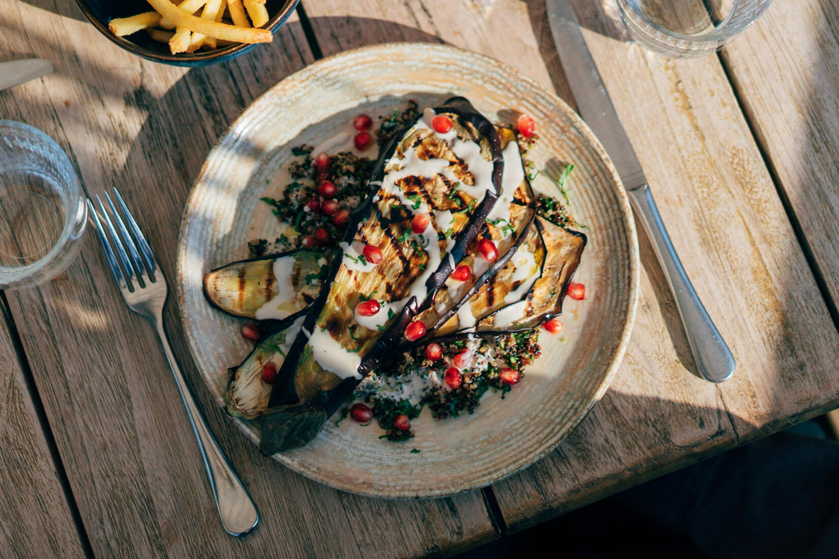 Grilled aubergine & tahini, quinoa, herbs, pomegranate & good oil with crispy shallots