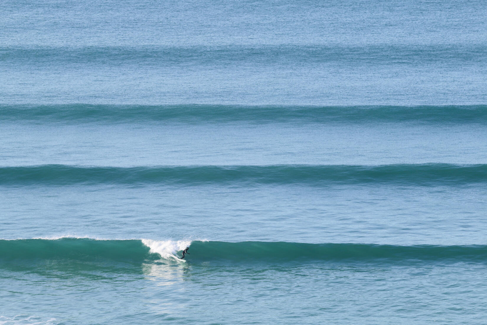 A surfer rides a wave