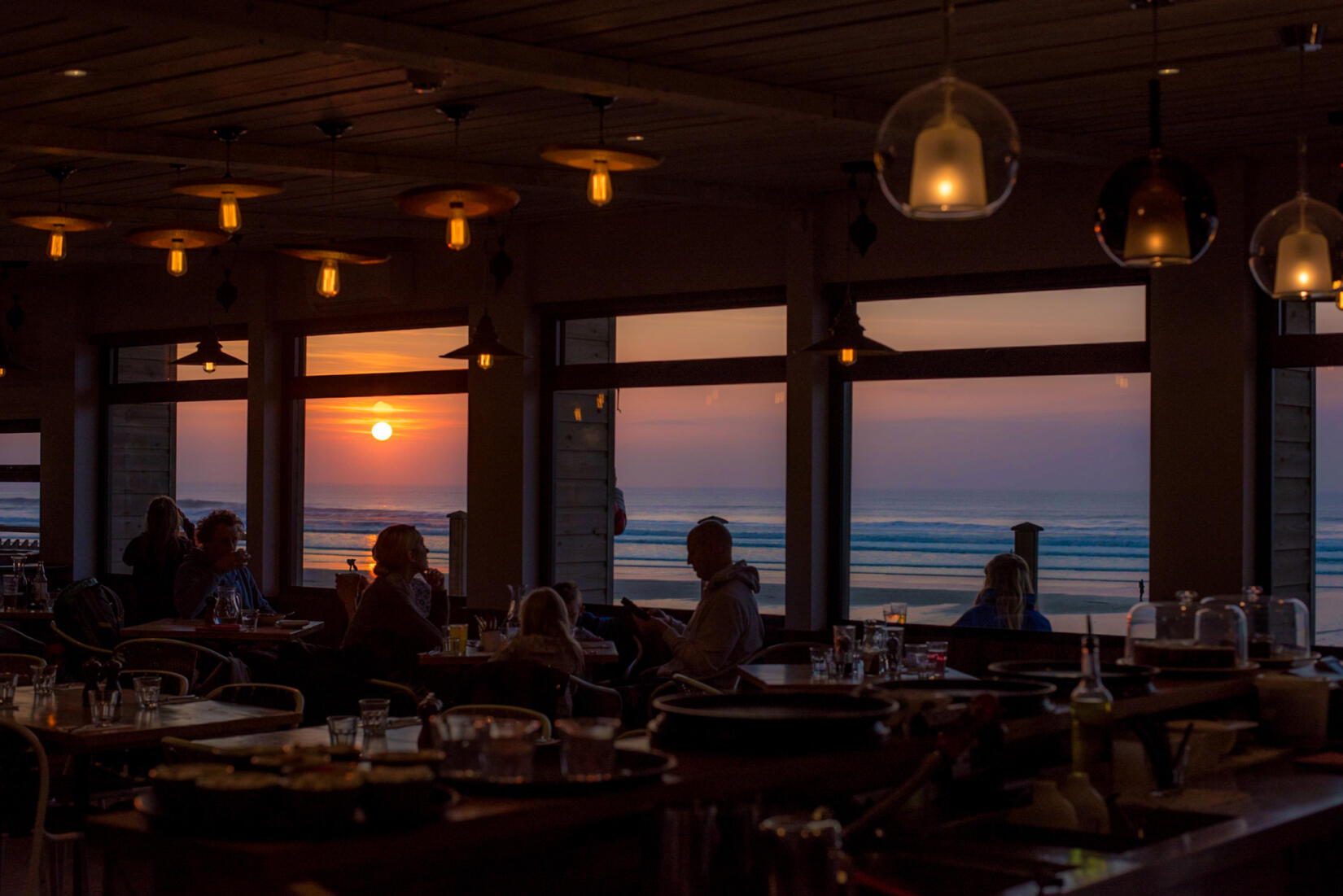 Dinner in the Beach Hut with the sun setting over the sea