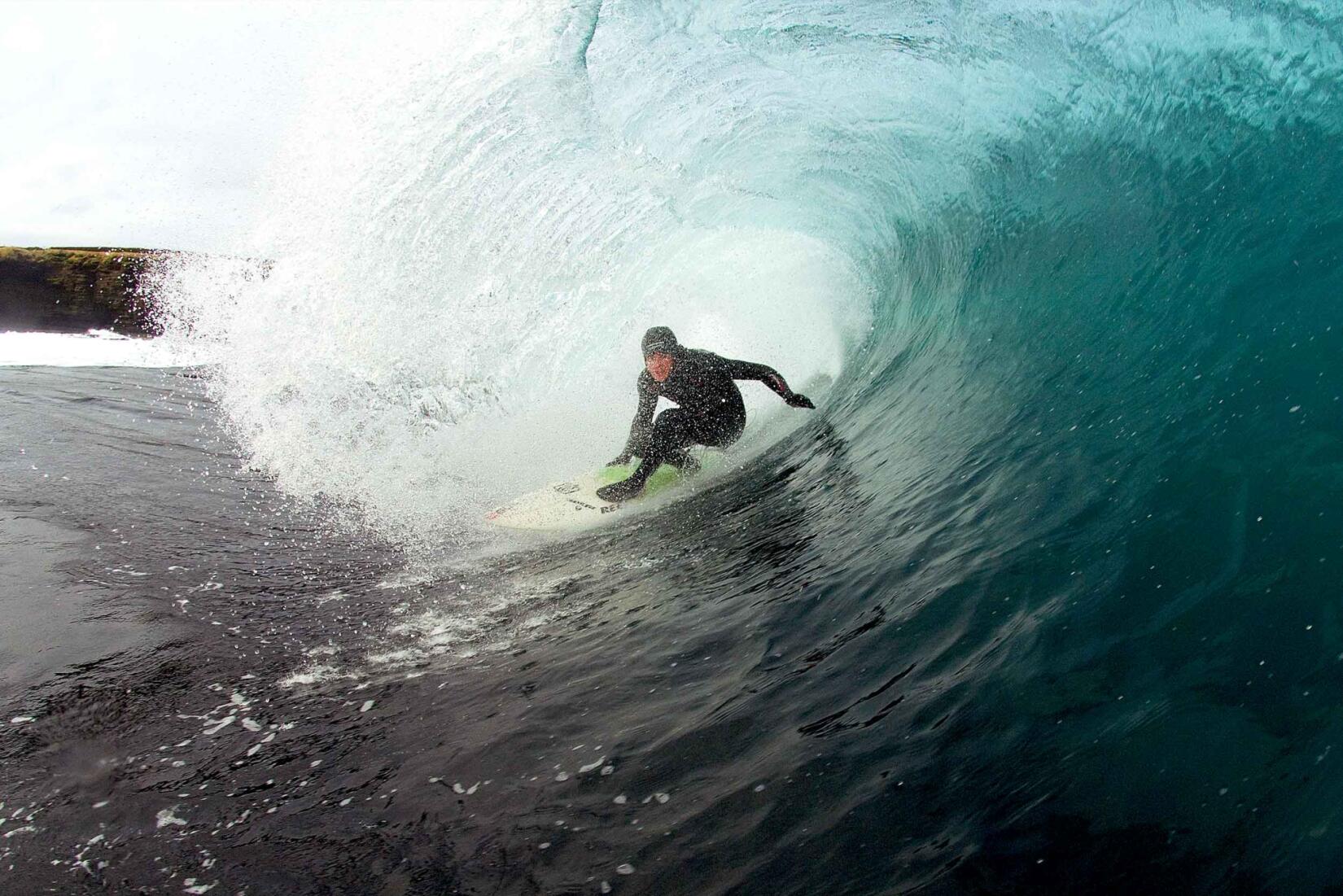 A surfer in a barrel wave