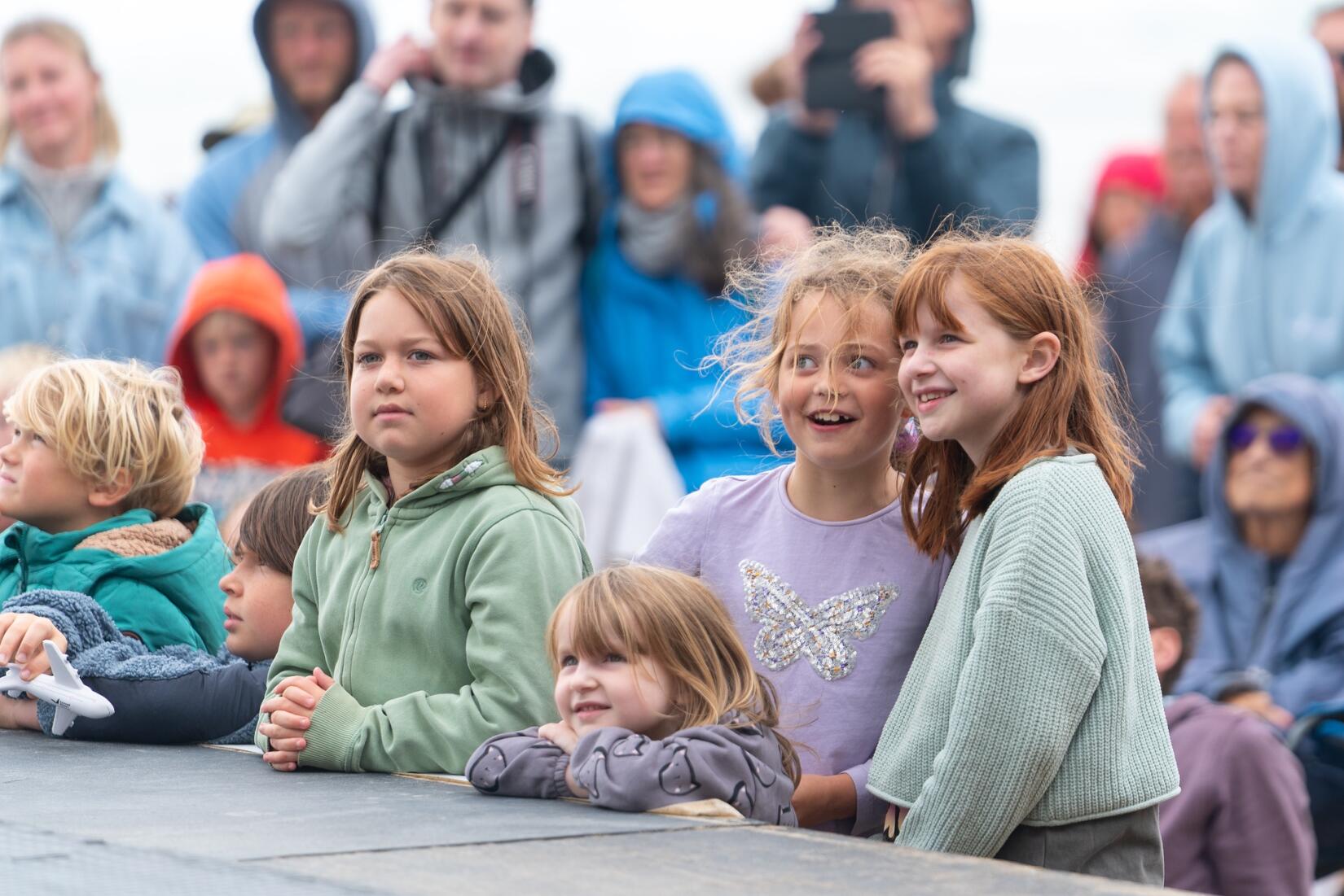 Crowd smiling watching WILD performance at WILD on the Beach at Watergate Bay
