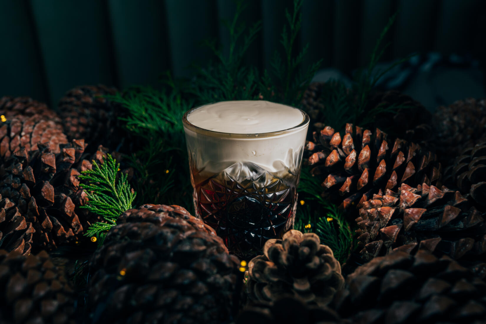 Watergate whiteout cocktail surrounded by pinecones