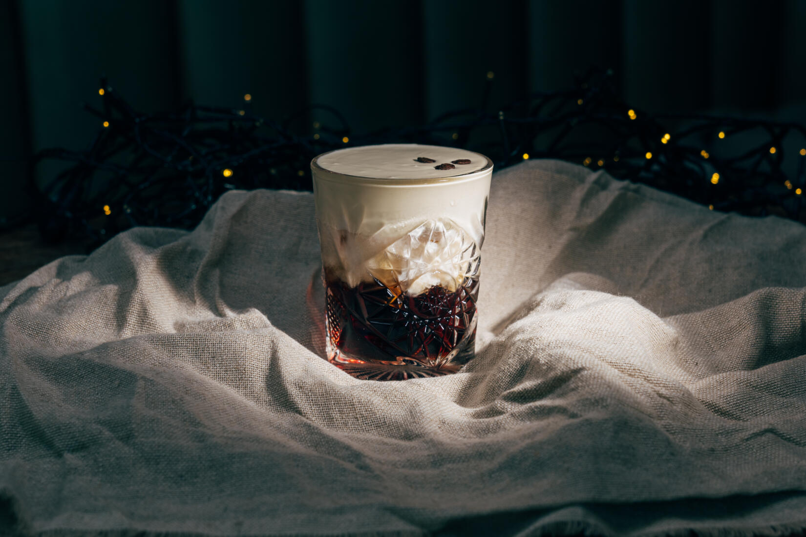 Watergate whiteout cocktail with fairy lights in the background