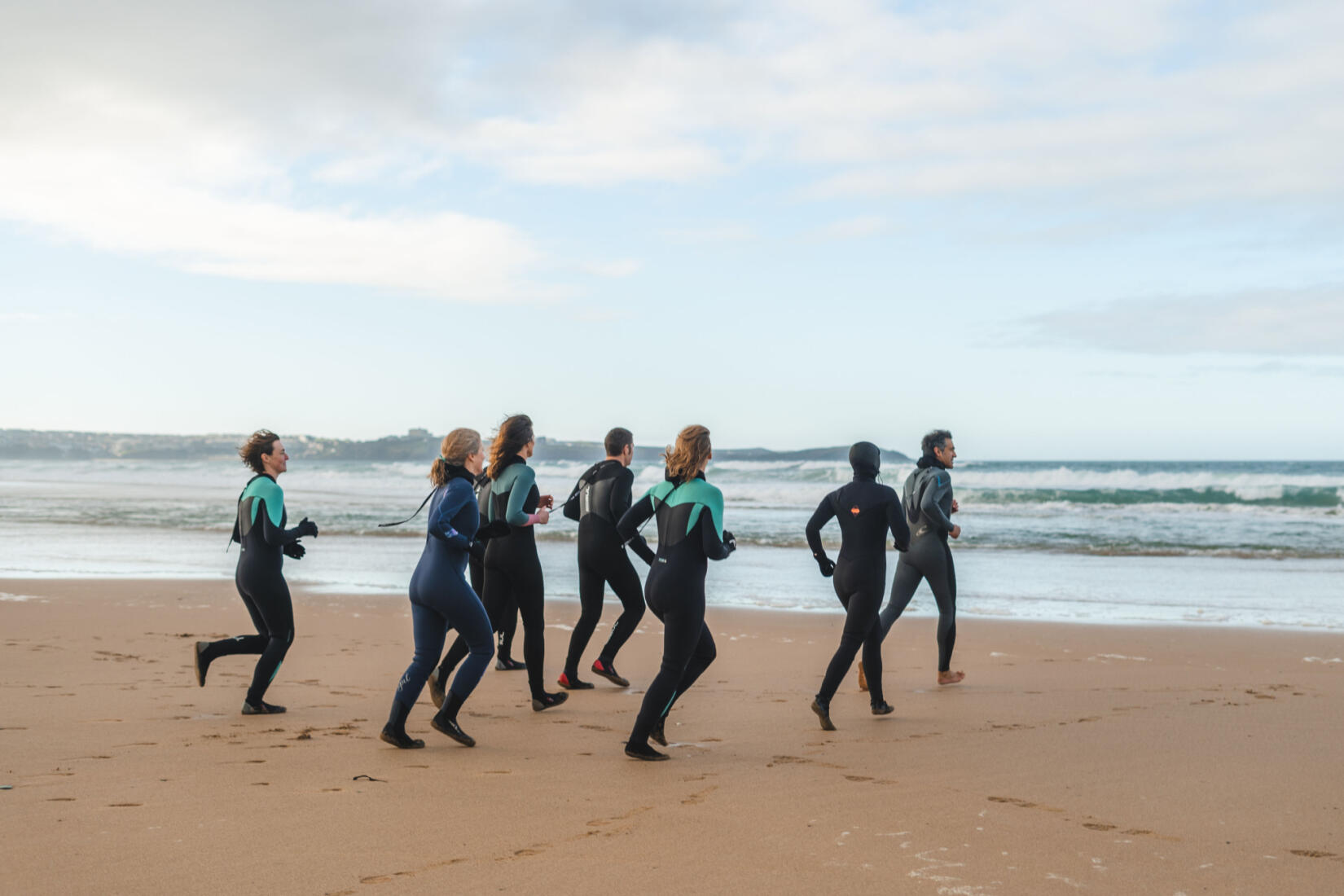 Swimmers running into the sea