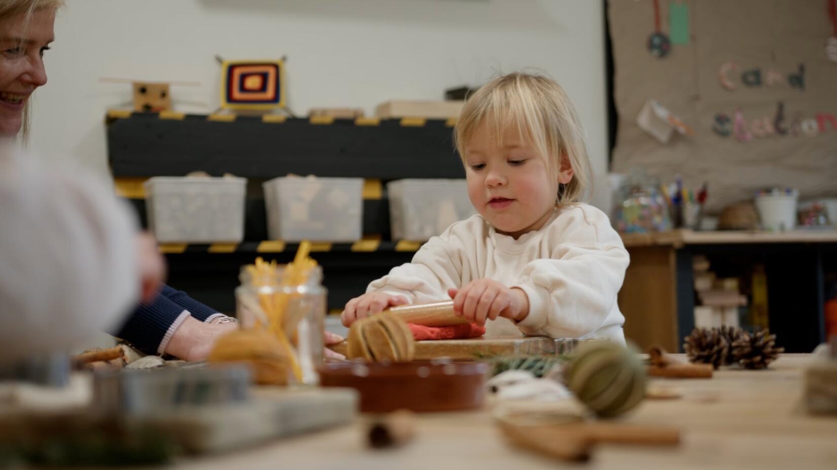 Little girl playing with playdough in Kids Zone